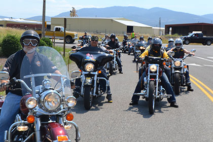 Riders line up on their motorcycles.