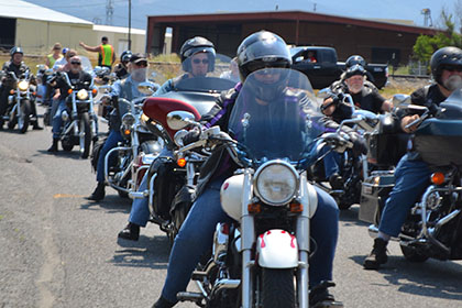 A line of riders on their motorcycles.