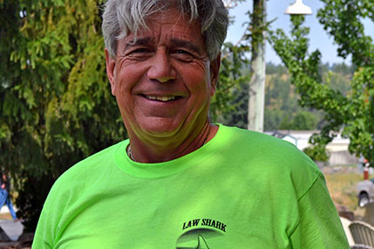 Smiling man wearing a green shirt.