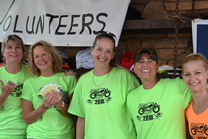 Four Ride for Life committee members and a volunteer pose for a photograph.