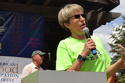 Ride for Life committee member speaking on a microphone.