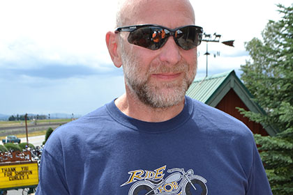 Man with sunglasses showing his Platinum Sponsor plaque.