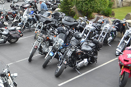 Parking lot filled with motorcycles.