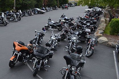 Motorcycles lined up in the parking lot.