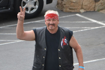 Man with red bandana in the parking lot.