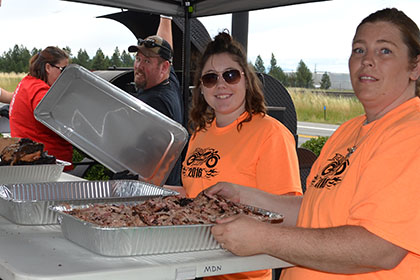 Ride for Life volunteers and others getting the barbecued food ready.
