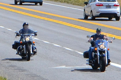 Some riders on the road.