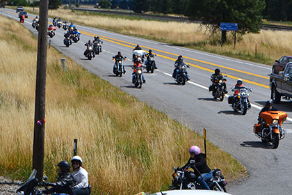 Line of motorcylces arriving at the event.
