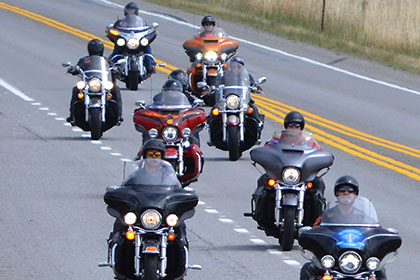 Group of eight riders approach the event.